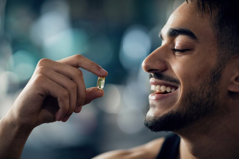 Best,Multivitamins.,Portrait,Of,Handsome,Young,Arab,Guy,Holding,Supplement